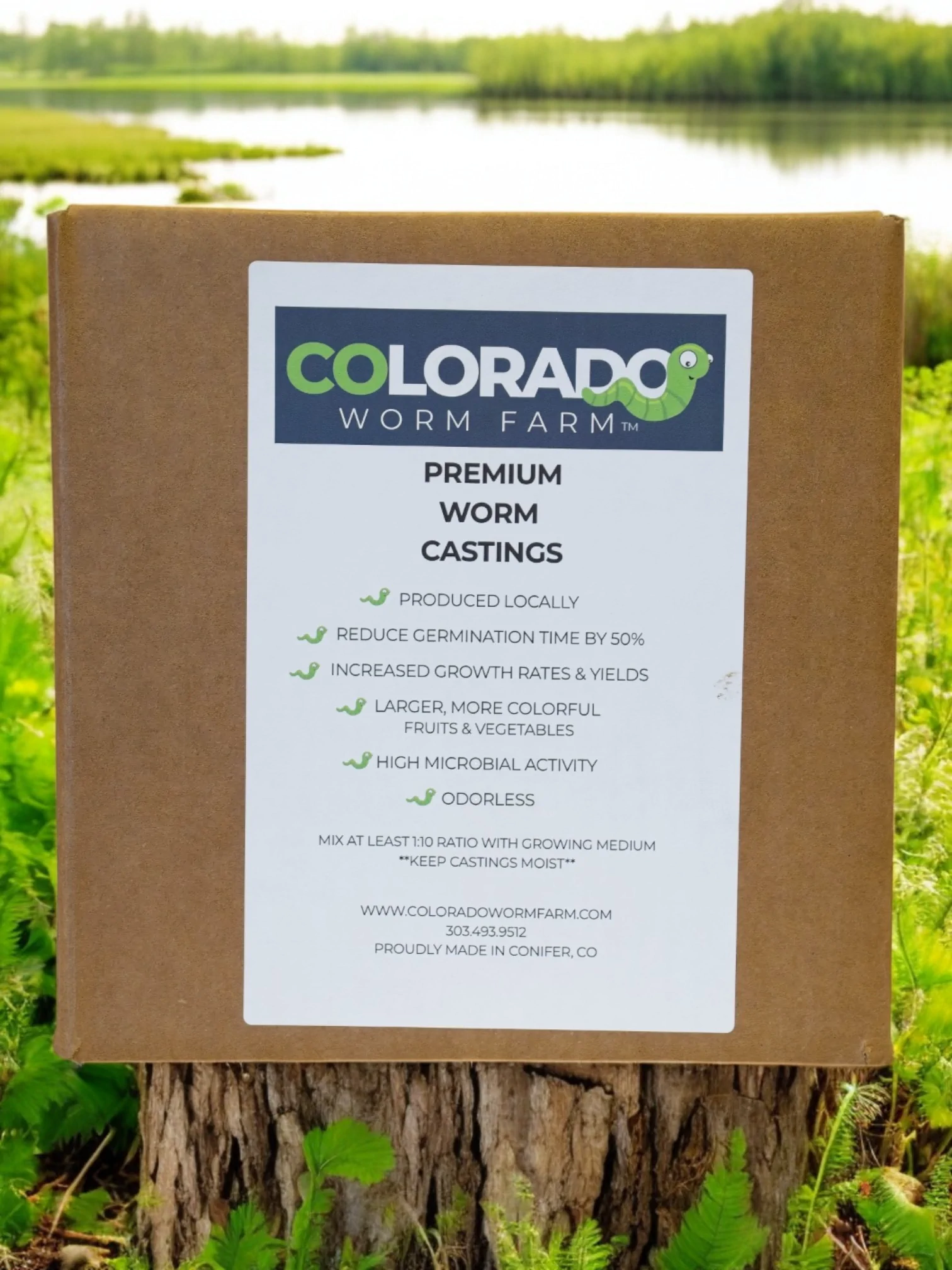 A box labeled "Colorado Worm Farm Premium Worm Castings" sits outdoors, listing benefits such as reduced germination time, increased yields, high microbial activity, and being odorless.